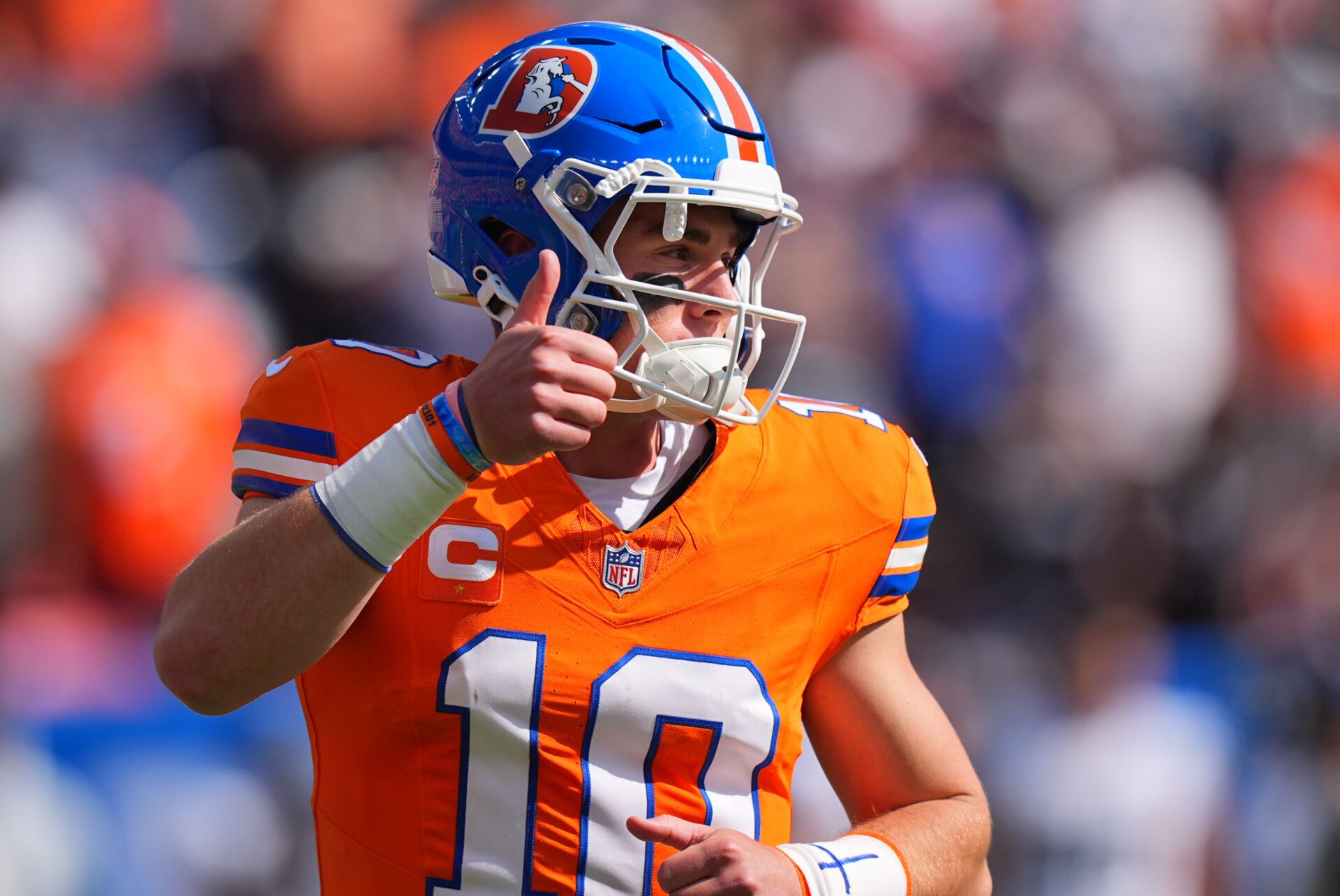 Denver Broncos linebacker Nik Bonitto (15) gives a thumbs up in the first quarter against the Las Vegas Raiders at Empower Field at Mile High.