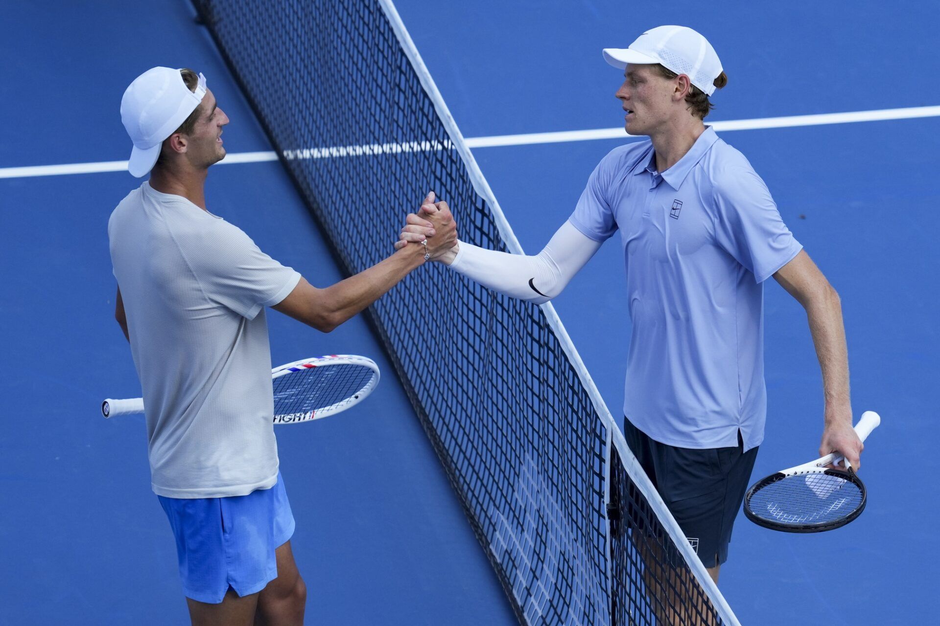 Jannik Sinner (ITA) right, meets Terence Atmane (FRA) at the net after their match during the Cincinnati Open at the Lindner Family Tennis Center.