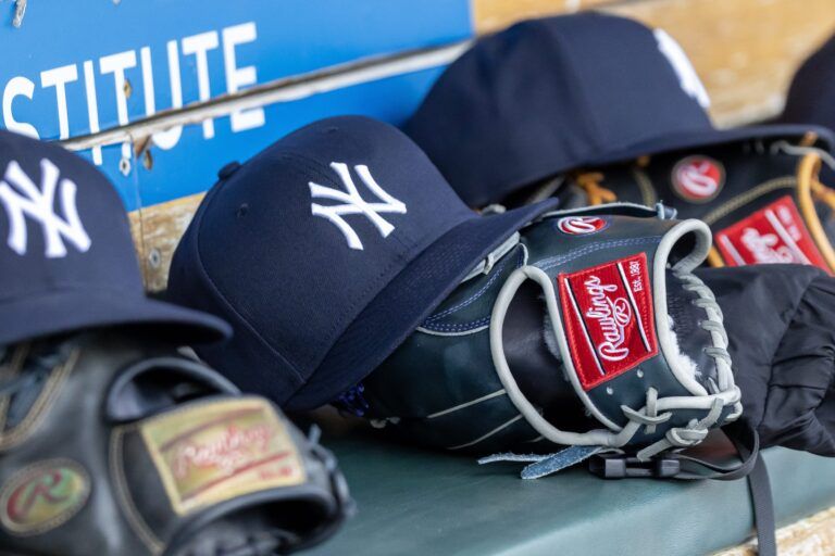 New York Yankees baseball hats and gloves in the dugout out in the eighth inning against the Detroit Tigers at Comerica Park.