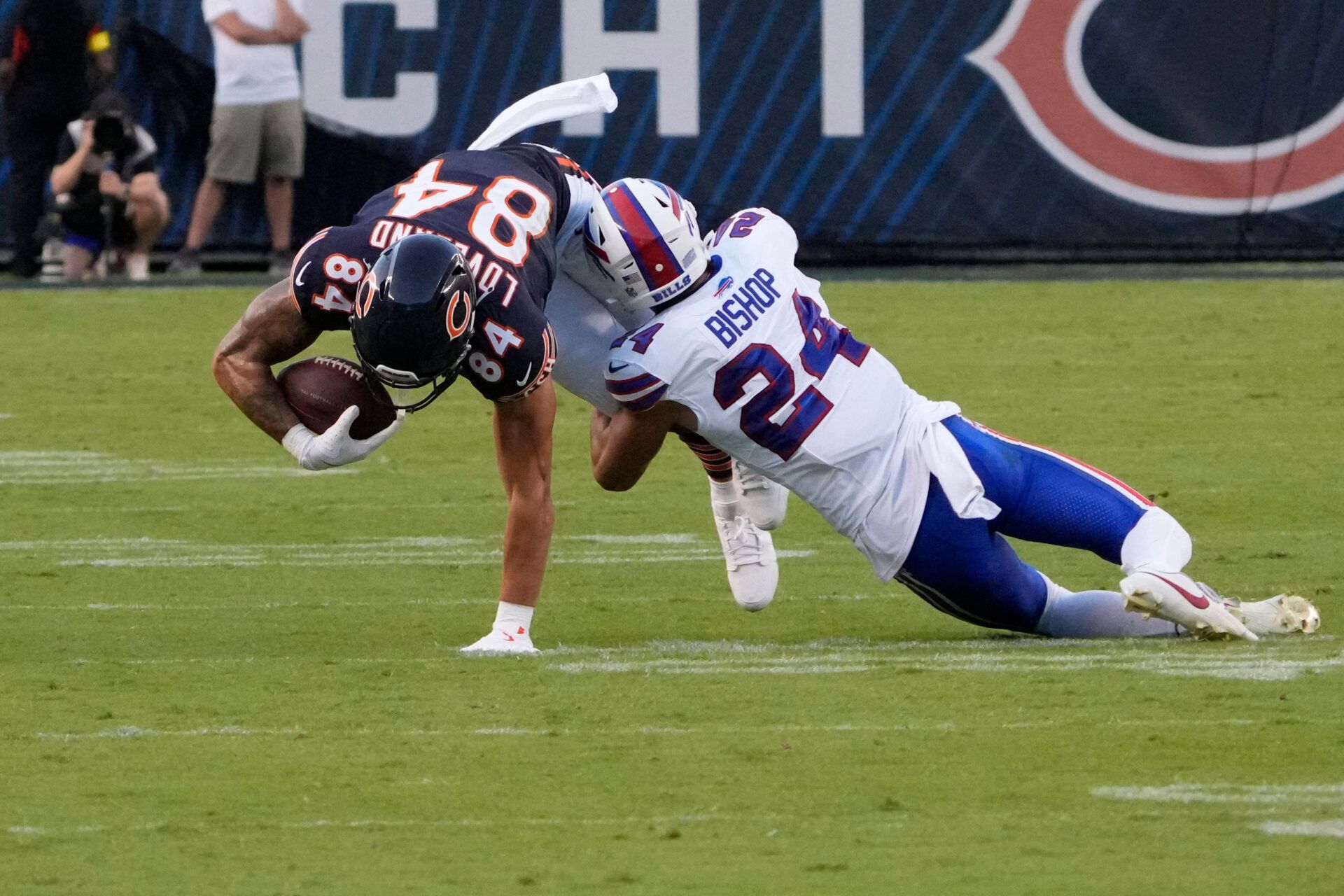 Buffalo Bills safety Cole Bishop (24) tackles Chicago Bears tight end Colston Loveland (84) during the first quarter at Soldier Field.