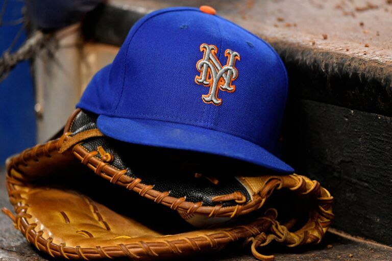 A general view of a New York Mets hat and glove on the steps of the dugout in the game between the Miami Marlins and the New York Mets at Marlins Park.