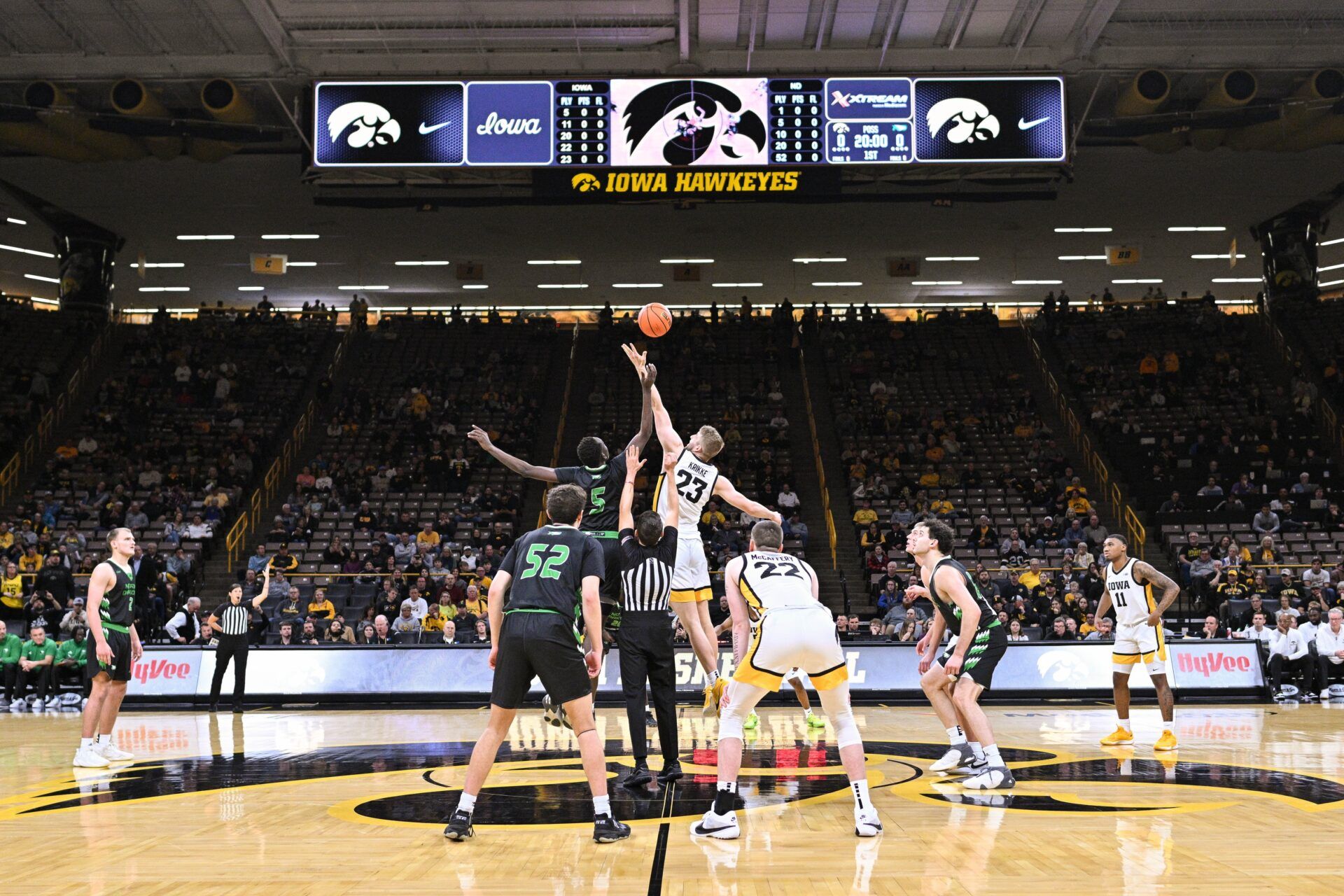 North Dakota Fighting Hawks forward Deng Mayar (5) and Iowa Hawkeyes forward Ben Krikke (23) battle for the opening tipoff during the first half at Carver-Hawkeye Arena.
