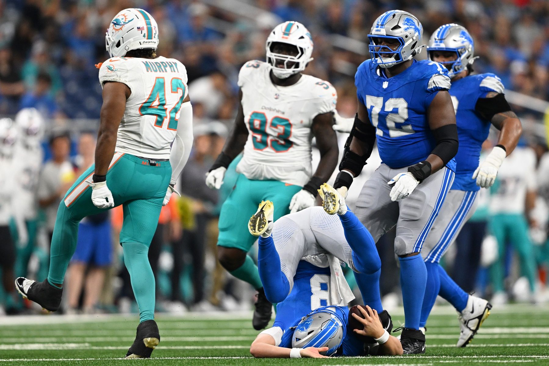 Miami Dolphins linebacker Grayson Murphy (42) celebrates after sacking Detroit Lions quarterback Kyle Allen (8) in the first quarter of their preseason game at Ford Field.