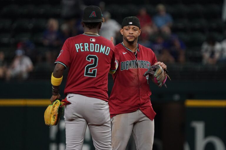 Arizona Diamondbacks shortstop Geraldo Perdomo (2) and second baseman Ketel Marte (4) shake hands following the game against the Texas Rangers at Globe Life Field.