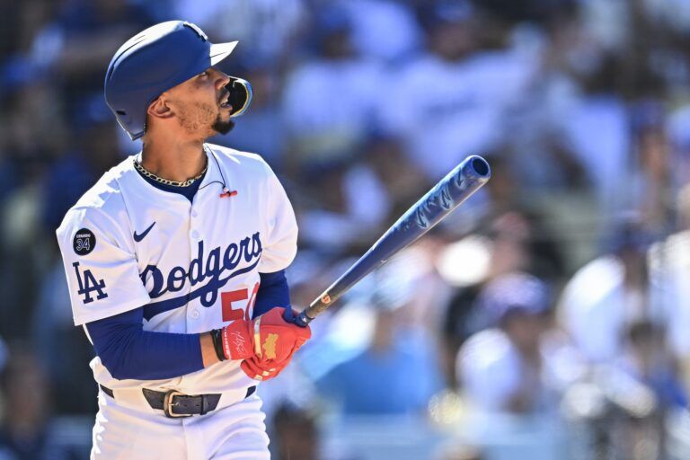 Los Angeles Dodgers shortstop Mookie Betts (50) hits a solo home run against the San Diego Padres during the eighth inning at Dodger Stadium.
