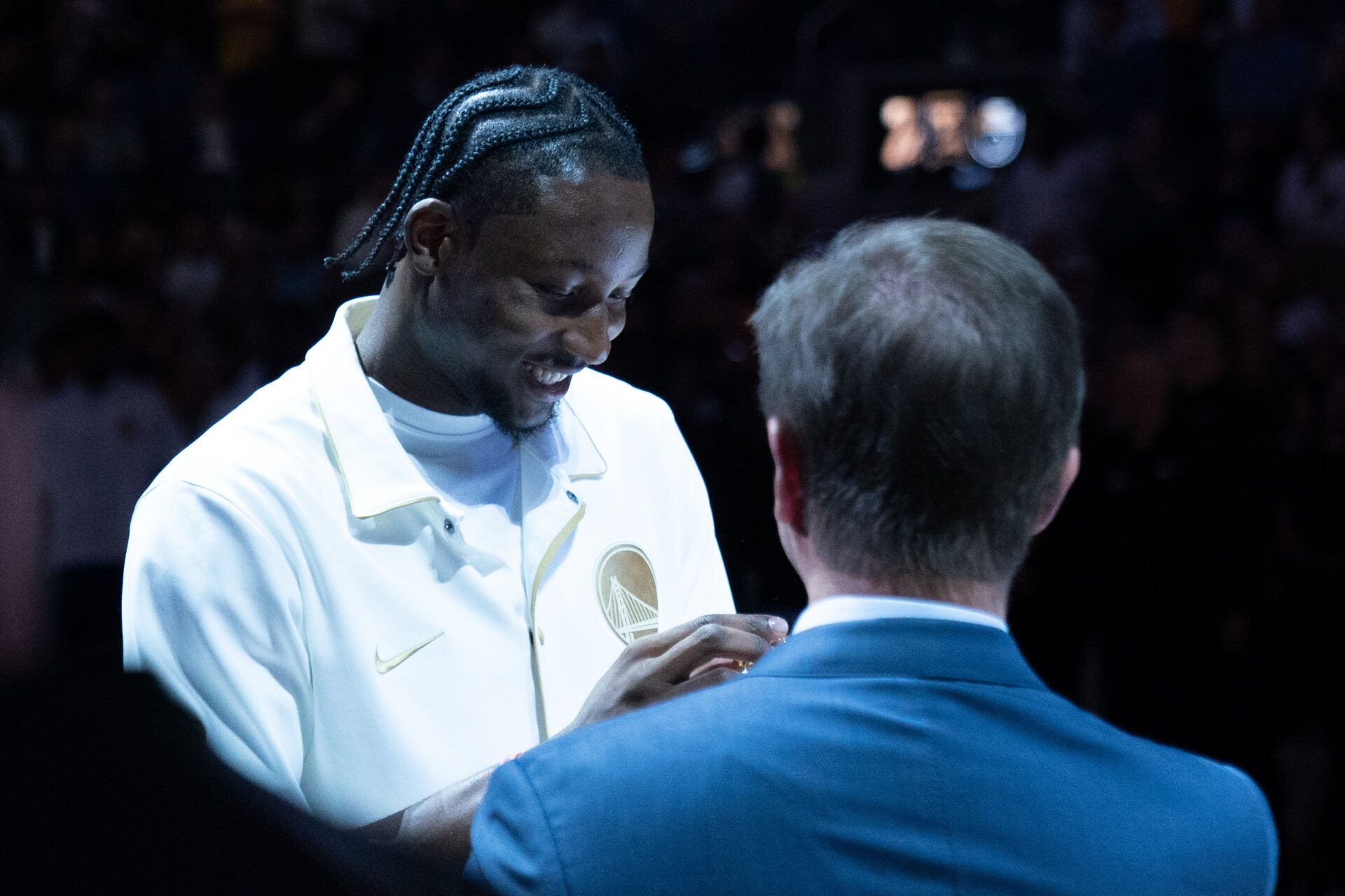 Golden State Warriors forward Jonathan Kuminga (00) receives his championship ring from owner Joe Lacob (right) before the game against the Los Angeles Lakers at Chase Center.