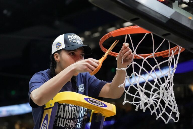 Connecticut Huskies guard Azzi Fudd (35) cuts a piece of the net after the national championship of the women's 2025 NCAA tournament against the South Carolina Gamecocks at Amalie Arena.
