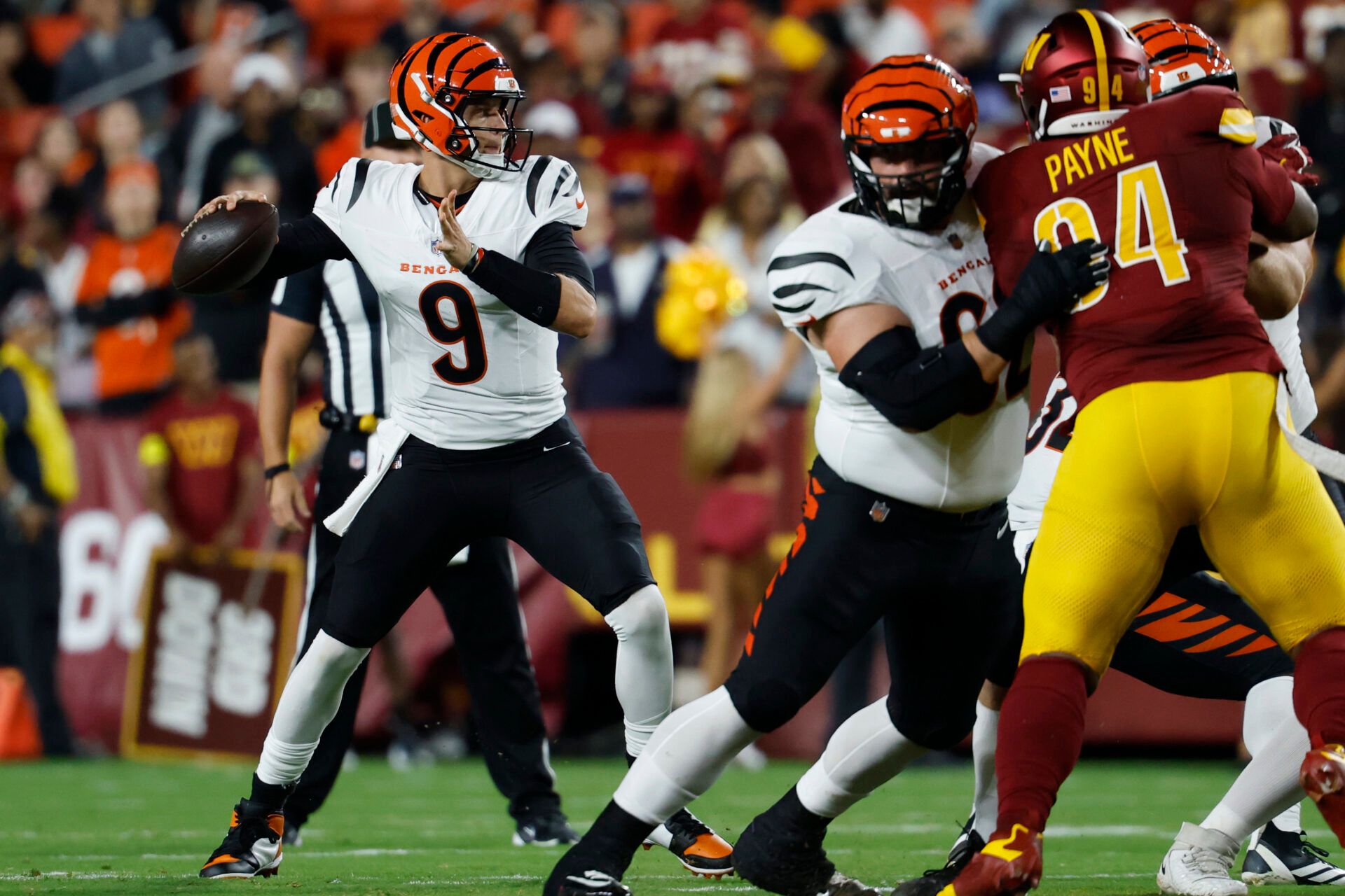 Cincinnati Bengals quarterback Joe Burrow (9) passes the ball as Washington Commanders defensive tackle Daron Payne (94) rushes during the first quarter at Northwest Stadium.