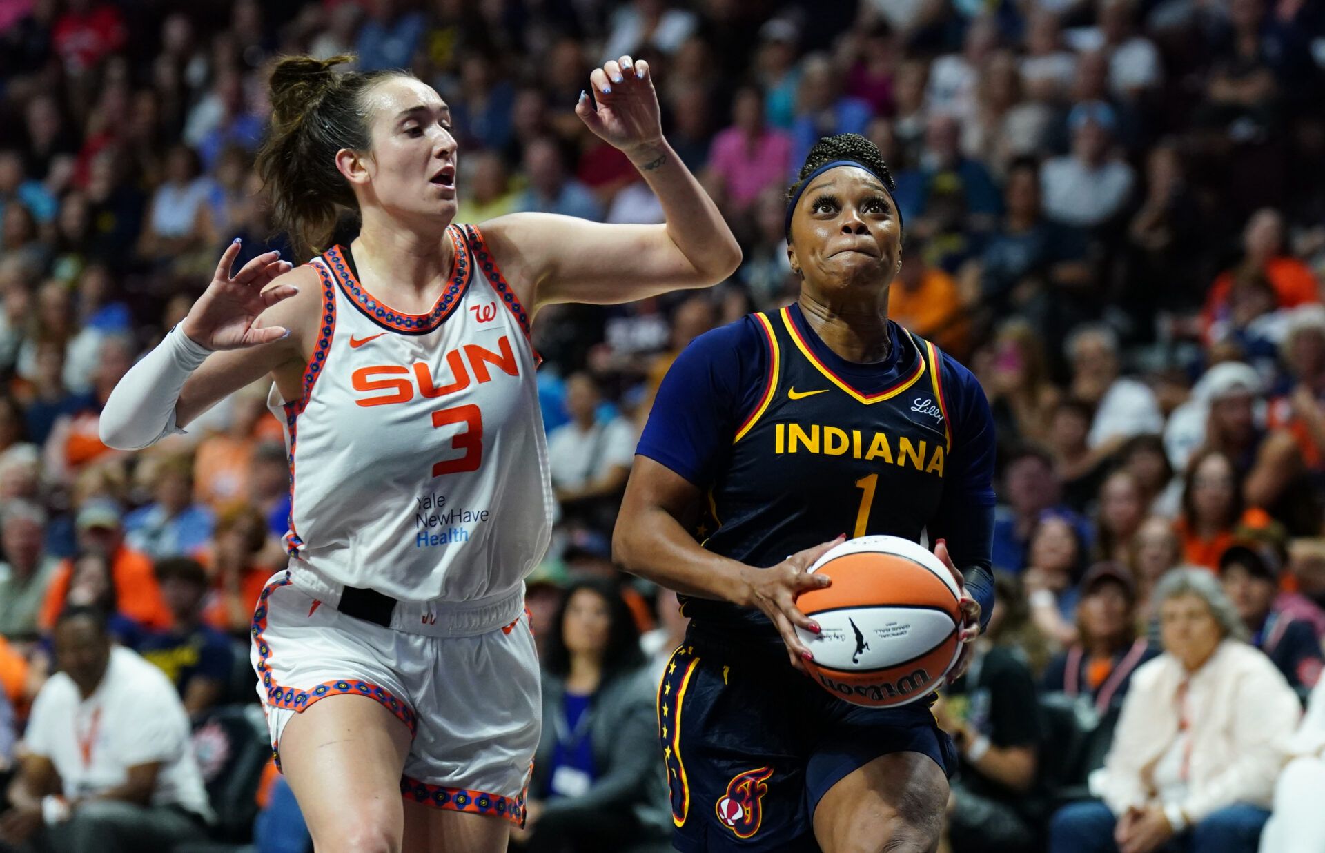 Indiana Fever guard Odyssey Sims (1) drives the ball to the basket against Connecticut Sun guard Marina Mabrey (3) in the second half at Mohegan Sun Arena.