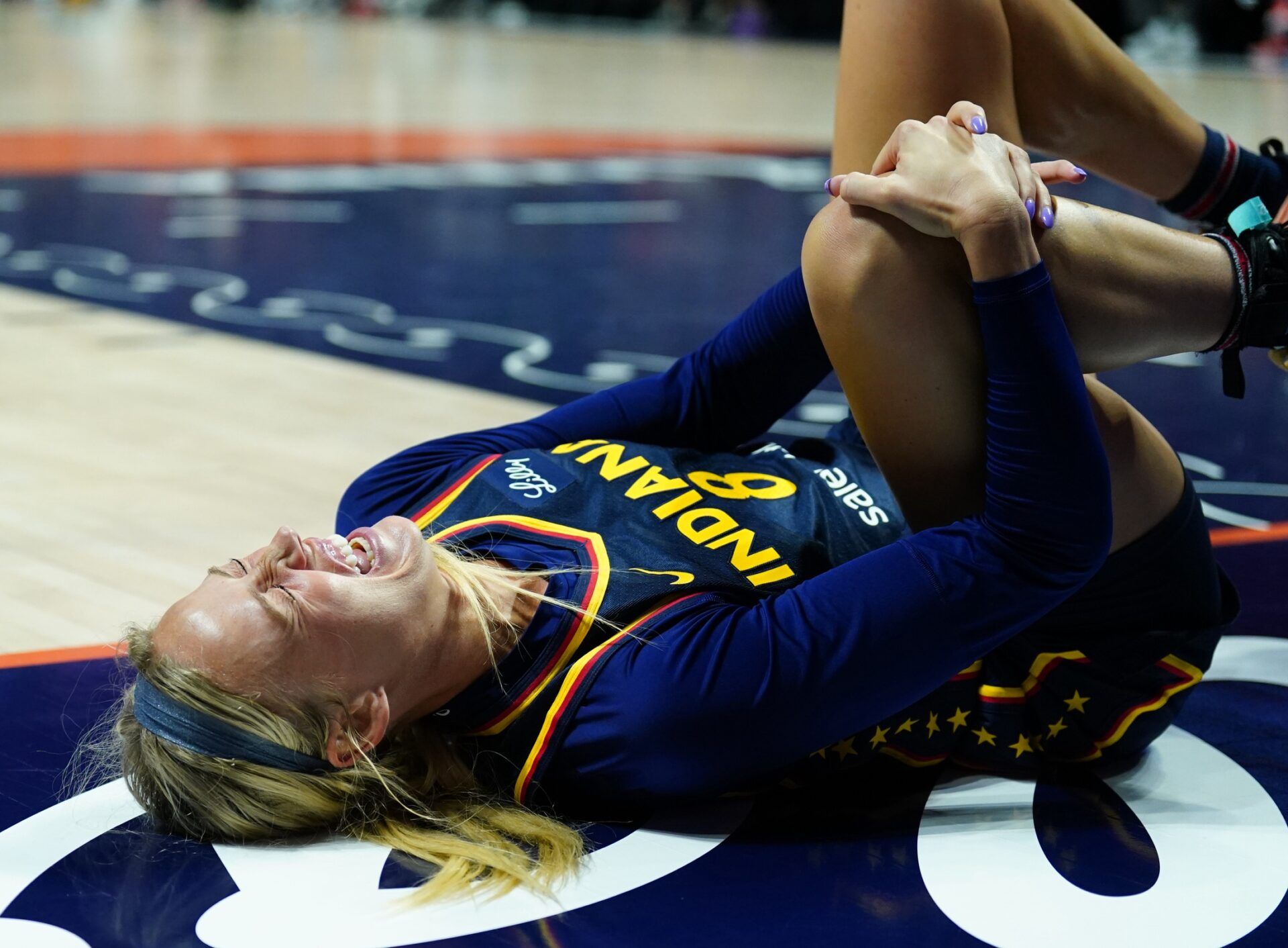 Indiana Fever guard Sophie Cunningham (8) on the court injured as they take on the Connecticut Sun in the first half at Mohegan Sun Arena.