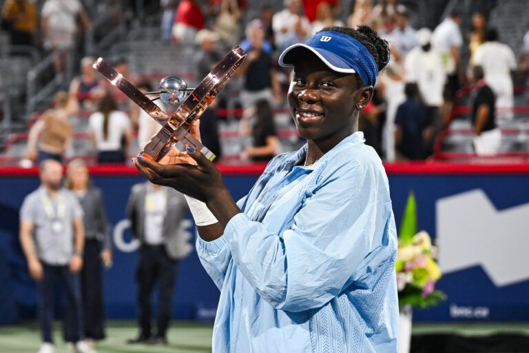 Victoria Mboko (CAN) tournament winner against Naomi Osaka (JPN) holds her trophy at IGA Stadium.