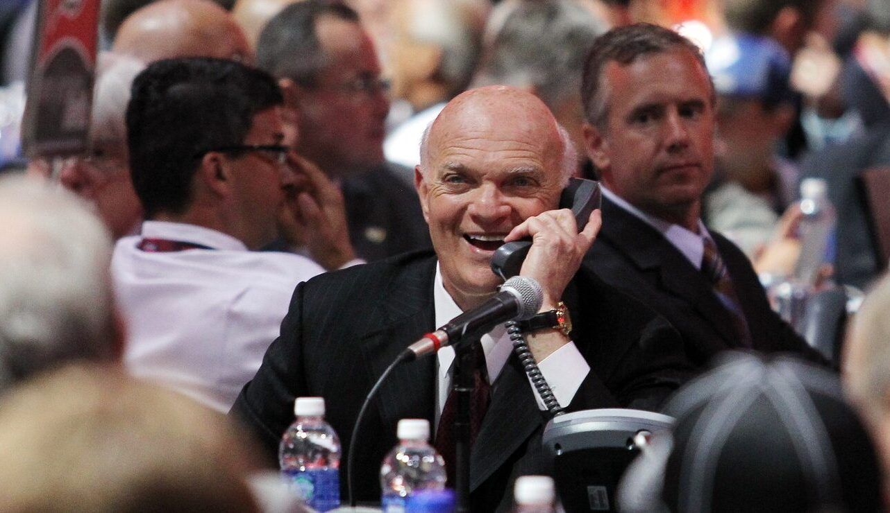 New Jersey Devils general manager Lou Lamoriello speaks on the phone during the 2013 NHL Draft at the Prudential Center.