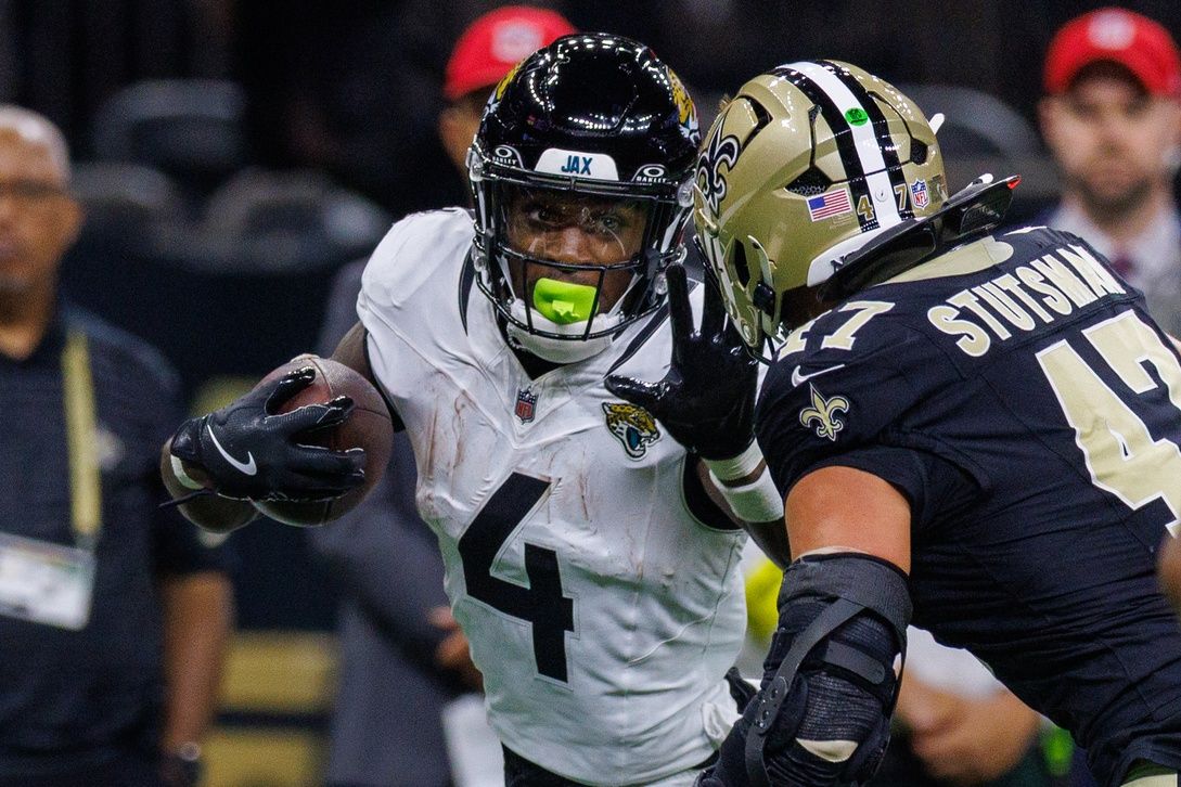 Jacksonville Jaguars running back Tank Bigsby (4) pushes away the tackle of New Orleans Saints linebacker Danny Stutsman (47) during the first half at Caesars Superdome.
