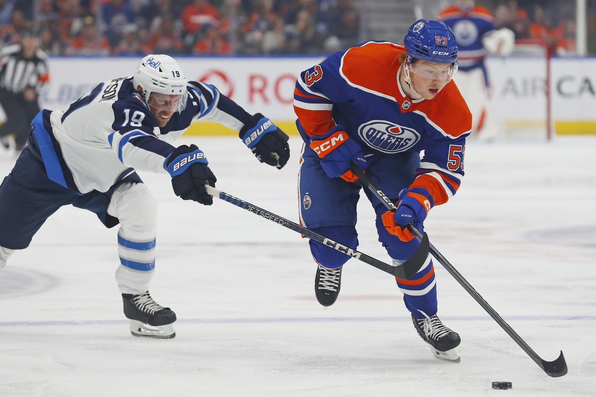 Winnipeg Jets forward David Gustafsson (19) plays for the puck against Edmonton Oilers forward Reid Schaefer (53)  during the first period at Rogers Place.