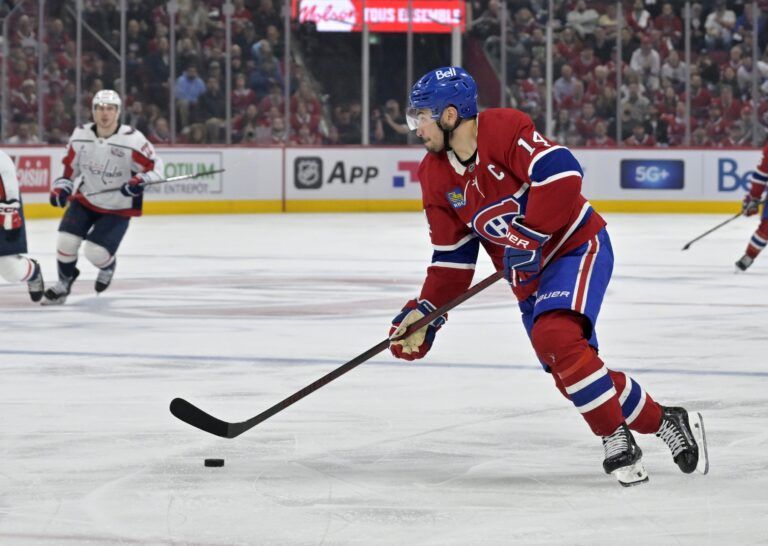 Montreal Canadiens forward Nick Suzuki (14) plays the puck during the second period in game three of the first round of the 2025 Stanley Cup Playoffs against the Washington Capitals at the Bell Centre.