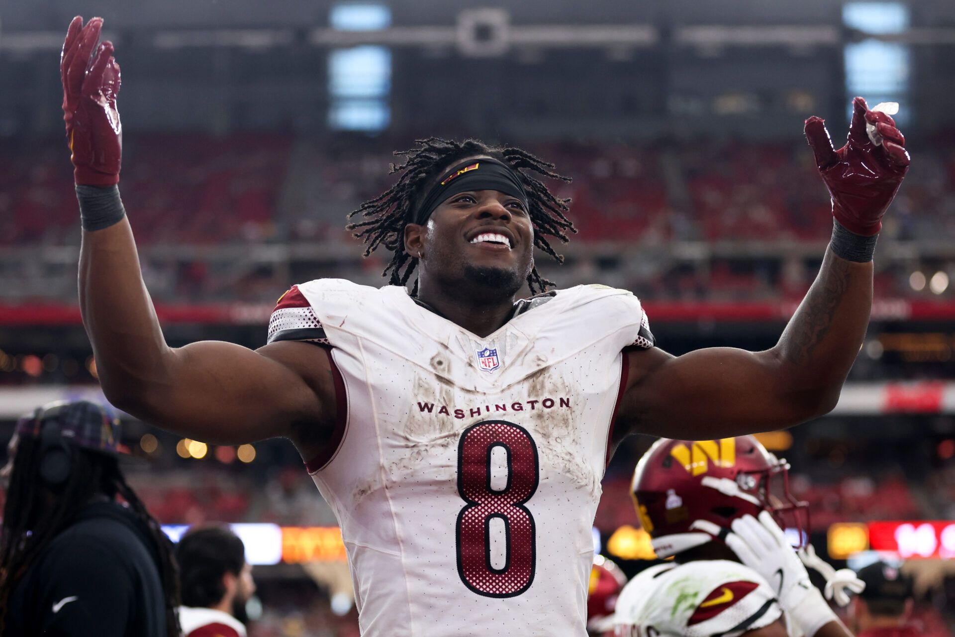 GLENDALE, ARIZONA - SEPTEMBER 29: Brian Robinson Jr. #8 of the Washington Commanders celebrates after a touchdown during the fourth quarter against the Arizona Cardinals at State Farm Stadium on September 29, 2024 in Glendale, Arizona. (Photo by Christian Petersen/Getty Images)