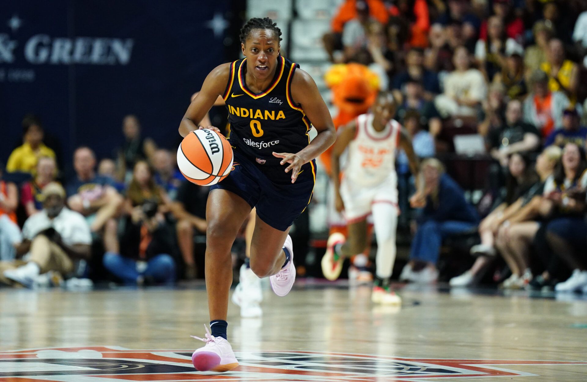 Indiana Fever guard Kelsey Mitchell (0) returns the ball against the Connecticut Sun in the second half at Mohegan Sun Arena.