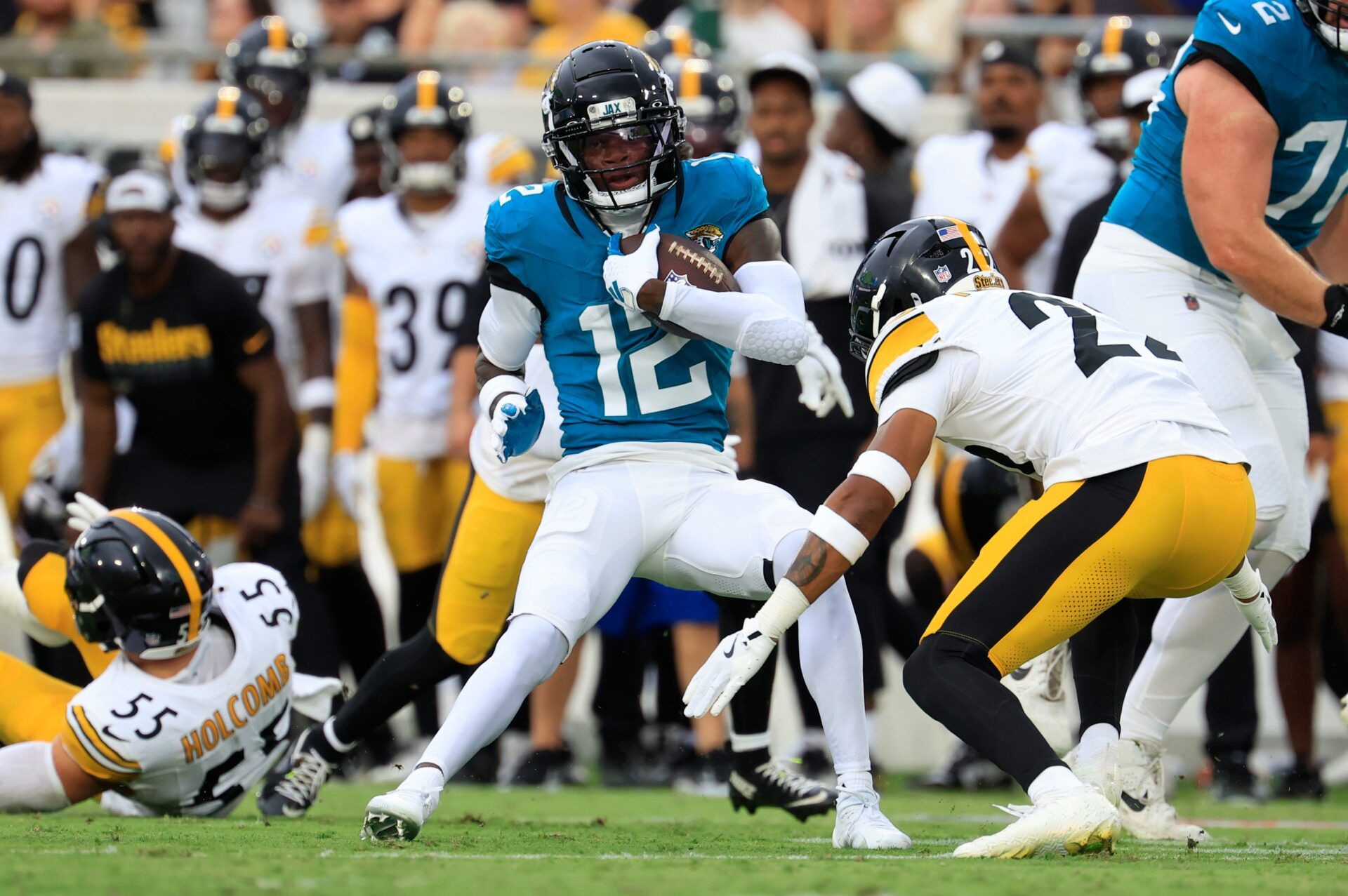 Jacksonville Jaguars wide receiver Travis Hunter (12) rushes for yards during the first quarter of an NFL preseason matchup at EverBank Stadium, Saturday, Aug. 9, 2025 in Jacksonville, Fla. [Corey Perrine/Florida Times-Union]
