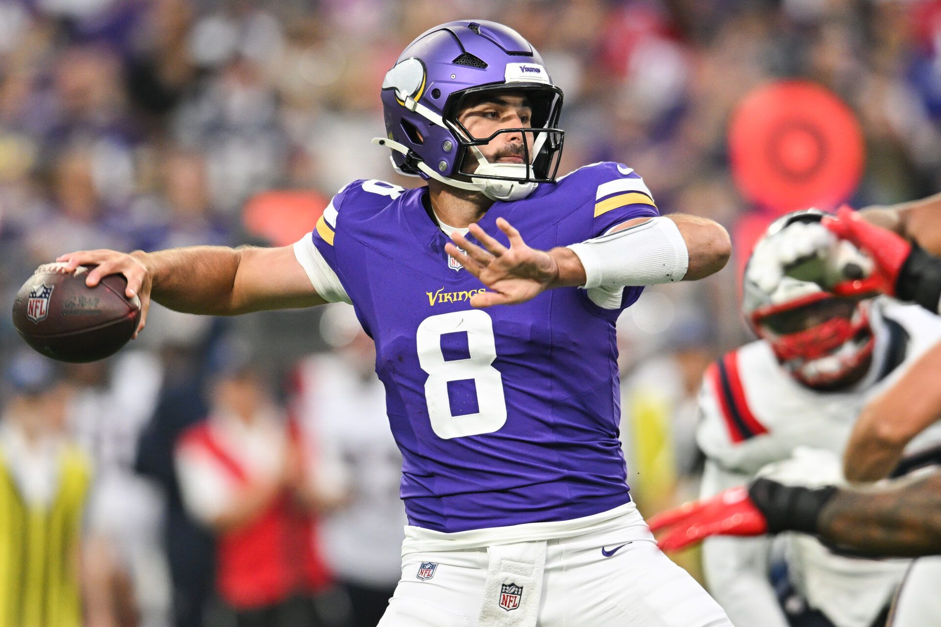 Minnesota Vikings quarterback Sam Howell (8) throws a pass against the New England Patriots during the first quarter at U.S. Bank Stadium.