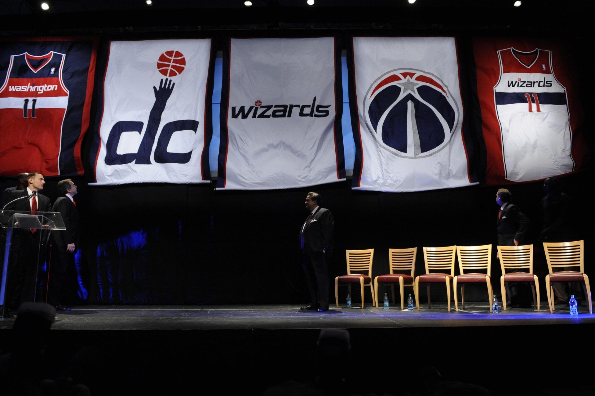 Banners with the new Washington Wizards colors and logos are unfurled during the unveiling of the new uniforms and logos at the Verizon Center.