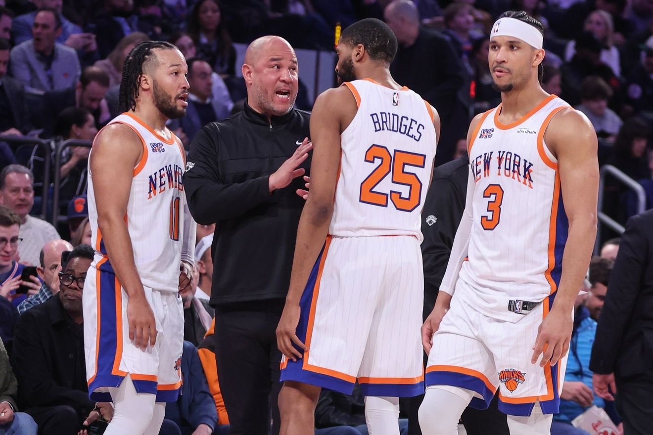 New York Knicks assistant coach Rick Brunson talks with New York Knicks guard Jalen Brunson (11), forward Mikal Bridges (25), and guard Josh Hart (3) during a timeout in the third quarter against the Boston Celtics at Madison Square Garden.
