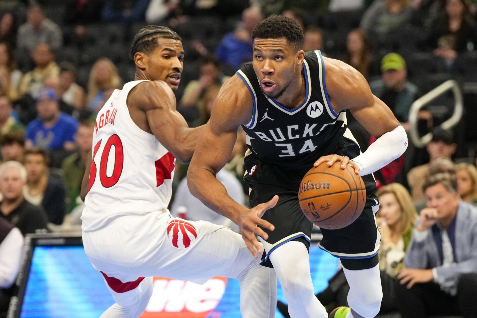 Milwaukee Bucks forward Giannis Antetokounmpo (34) drives for the basket around Toronto Raptors guard Ochai Agbaji (30) during the fourth quarter at Fiserv Forum.