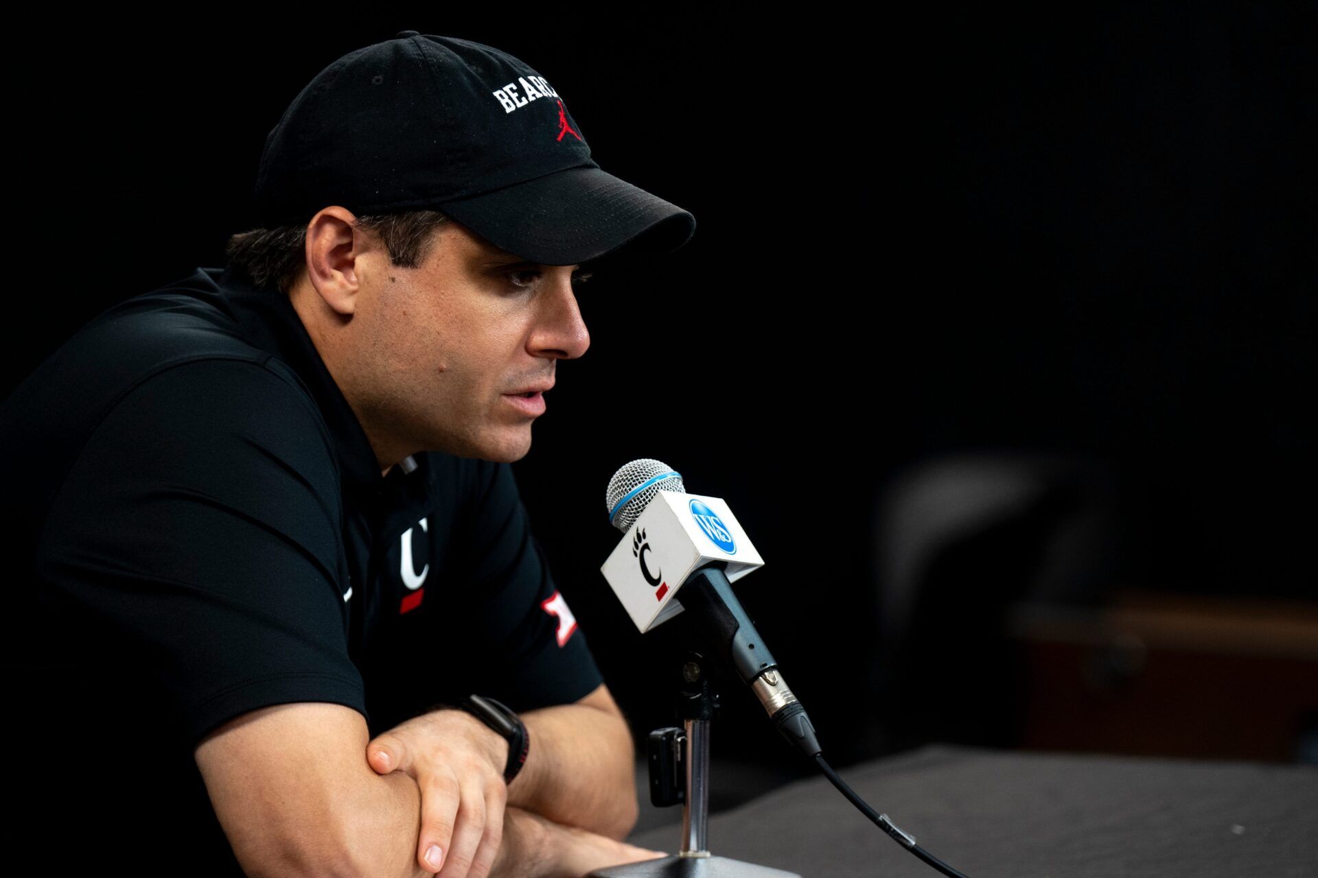 Cincinnati Bearcats head coach Wes Miller speaks at a podium at First Third Arena in Cincinnati on Wednesday, July 16, 2025.