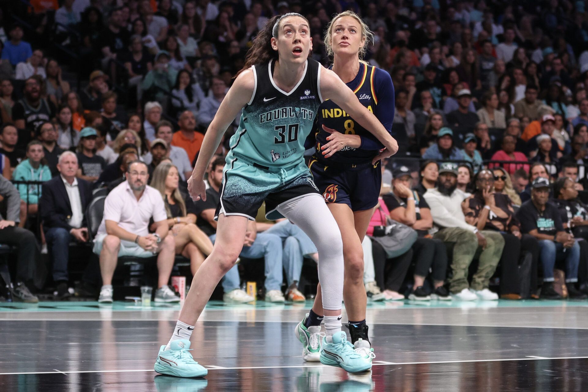 New York Liberty forward Breanna Stewart (30) and Indiana Fever guard Sophie Cunningham (8) box out for a rebound in the third quarter at Barclays Center.
