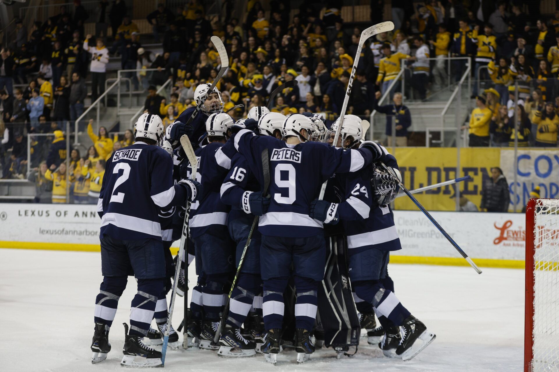 The Penn State Nittany Lions celebrate their win over the Michigan Wolverines at Yost Ice Arena.