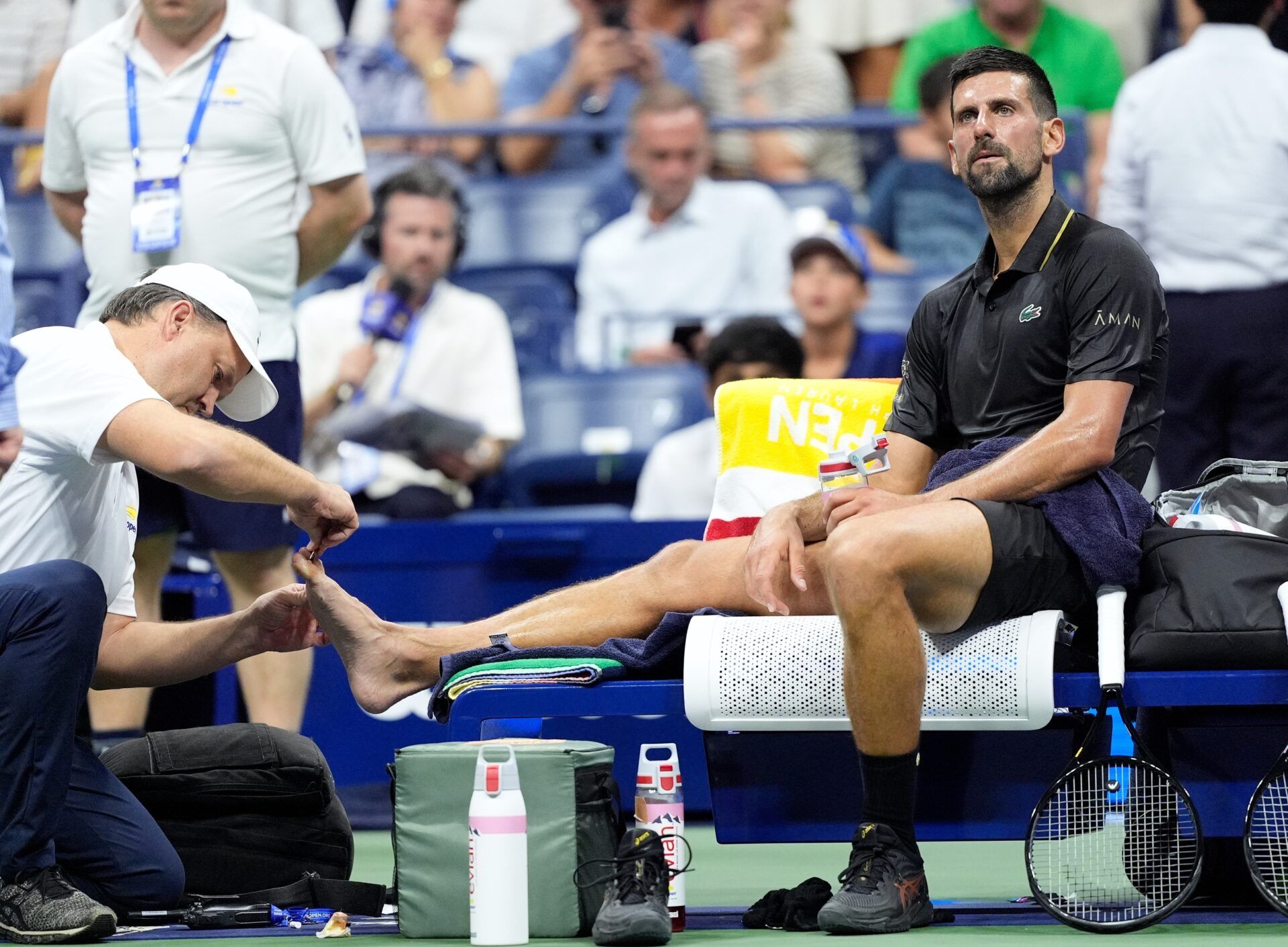 Novak Djokovic (SRB) gets his foot treated between sets against Learner Tien (USA) on day one of the 2025 U.S. Open tennis tournament at the USTA Billie Jean King National Tennis Center.