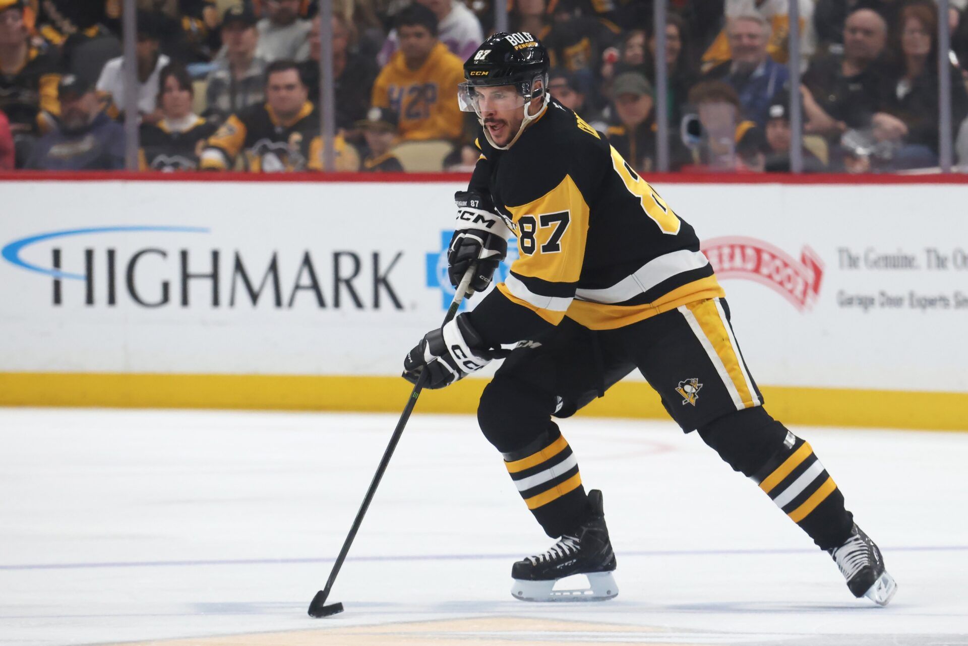 Pittsburgh Penguins center Sidney Crosby (87) handles the puck against the Boston Bruins during the third period at PPG Paints Arena.