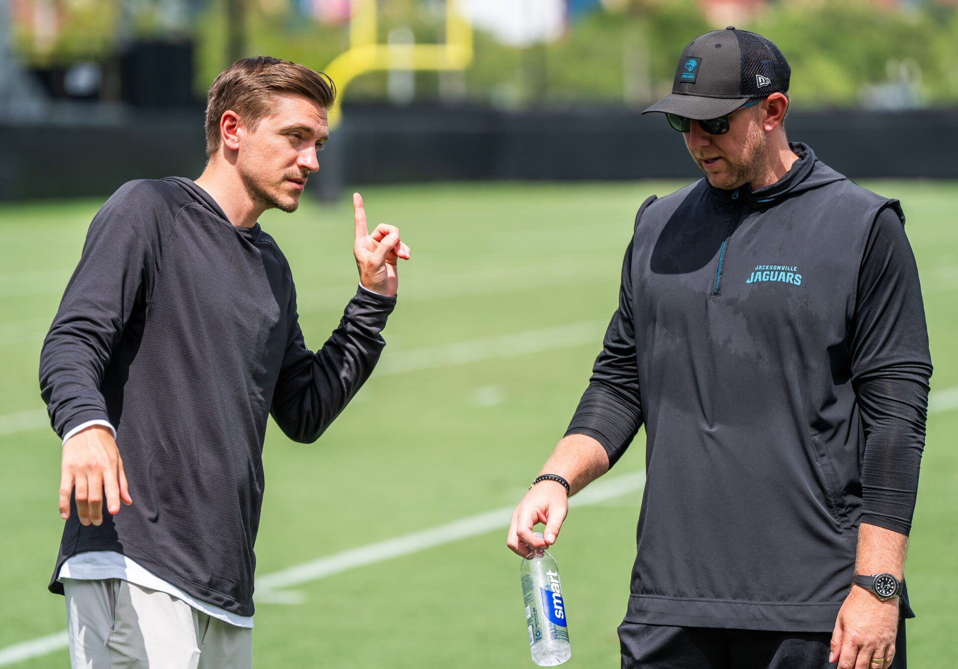 Jacksonville Jaguars general manager James Gladstone, left, talks with Jacksonville Jaguars head coach Liam Coen, right, after the. Jacksonville Jaguars’ mandatory minicamp Tuesday June 10, 2025 at the Miller Electric Center in Jacksonville, Fla. [Doug Engle/Florida Times-Union]