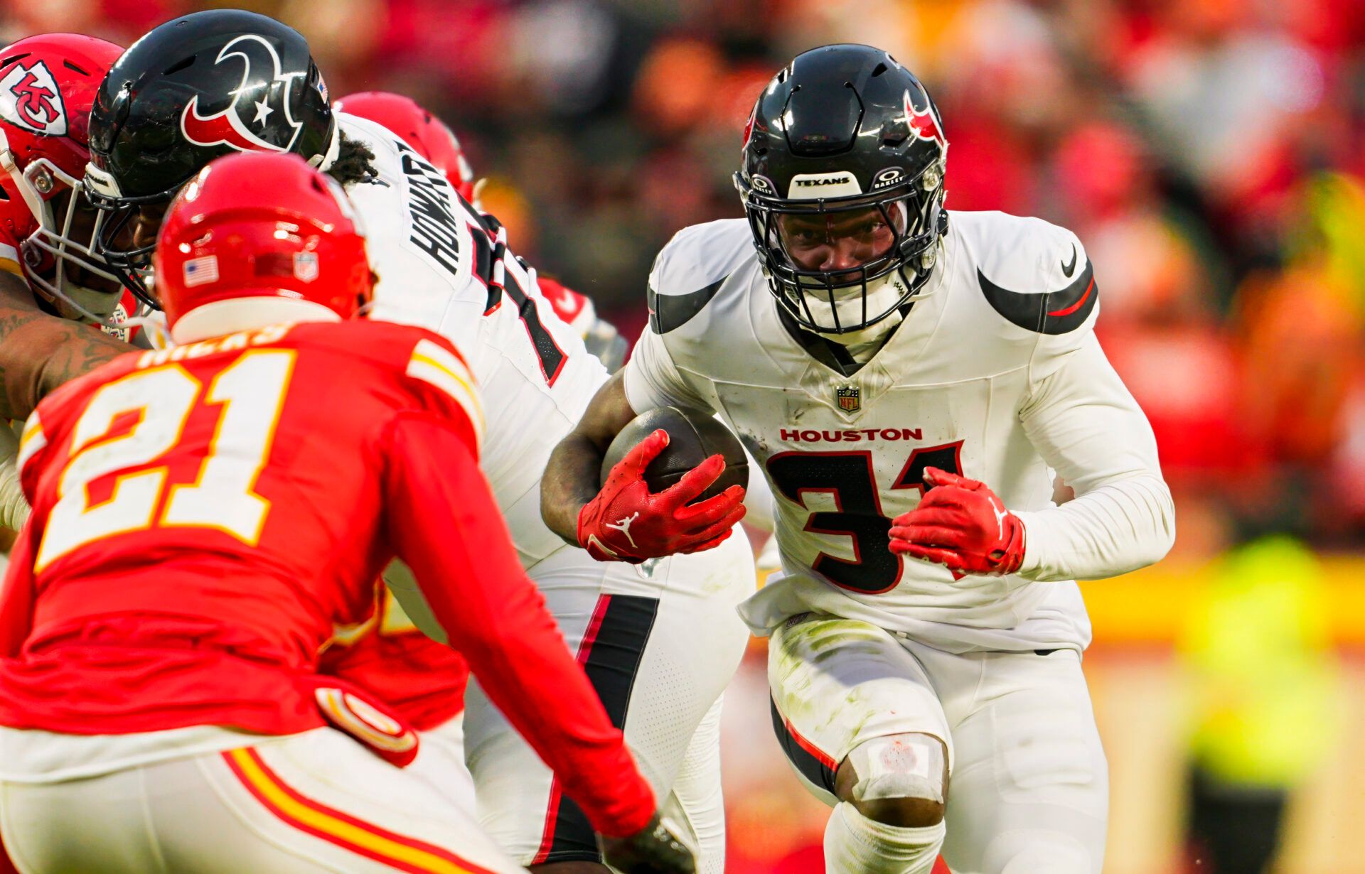 Houston Texans running back Dameon Pierce (31) runs the ball against Kansas City Chiefs safety Jaden Hicks (21) during the second half in a 2025 AFC divisional round game at GEHA Field at Arrowhead Stadium.
