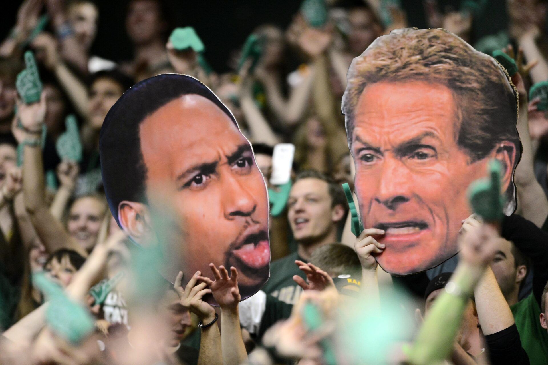 Colorado State Rams fans hold large cut outs of ESPN television personality Stephen A. Smith (left) and Skip Bayless (right) during the game against the New Mexico Lobos at Moby Arena. The Lobos defeated the Rams 91-82.