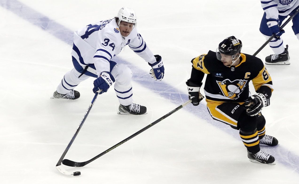 Toronto Maple Leafs center Auston Matthews (34) and Pittsburgh Penguins center Sidney Crosby (87) reach for the puck during the third period at PPG Paints Arena. Toronto won 4-1.