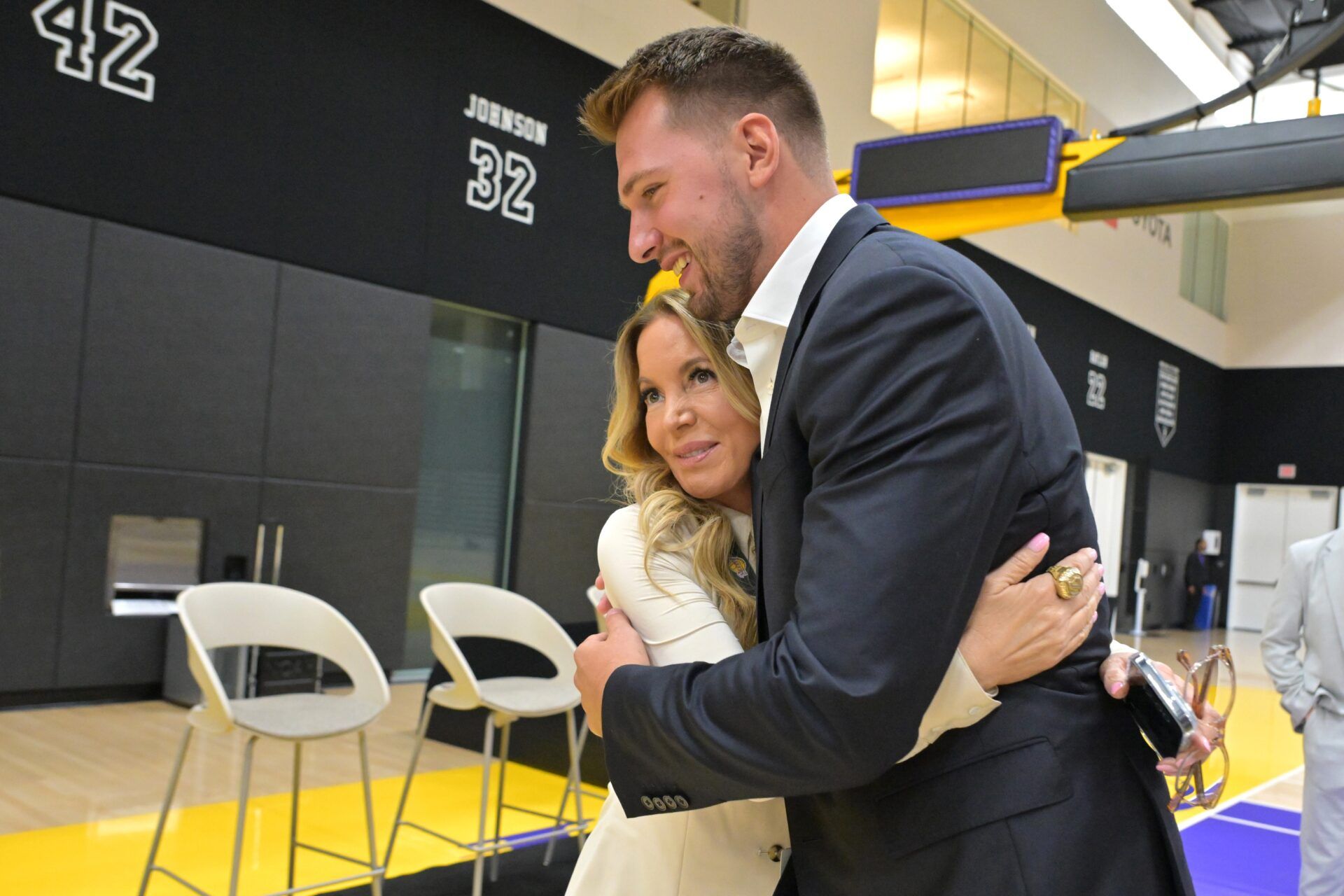 Los Angeles Lakers Luka Doncic (77) gets a hug from team co-owner Jeanie Buss following a press conference announcing the signing of his contract extension at UCLA Health Training Center.