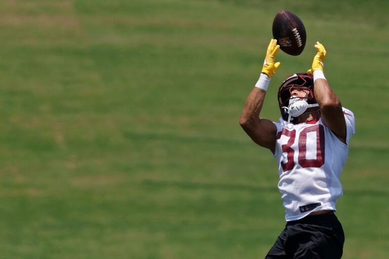 Washington Commanders running back Austin Ekeler (30) catches a pass during drills on day one of minicamp at Commanders Park.