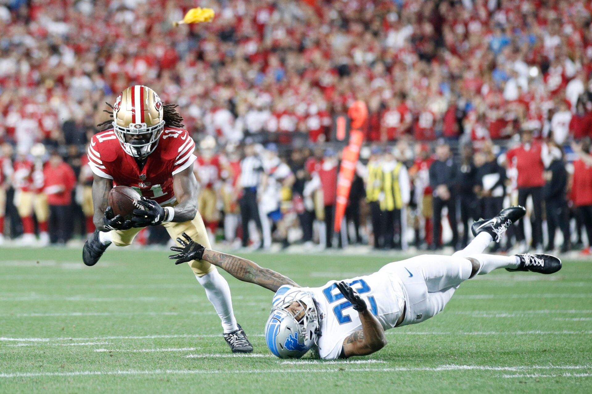 San Francisco 49ers wide receiver Brandon Aiyuk (11) catches the ball over Detroit Lions cornerback Kindle Vildor (29) in the third quarter of the NFC Championship game at Levi's Stadium in Santa Clara, Calif. on Sunday, January 28, 2024.