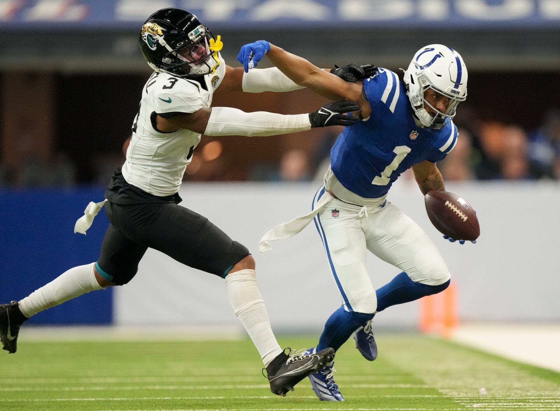 Indianapolis Colts wide receiver Josh Downs (1) reaches to push off Jacksonville Jaguars cornerback Tyson Campbell (3) on Sunday, Jan. 5, 2025, during a game against the Jacksonville Jaguars at Lucas Oil Stadium in Indianapolis.