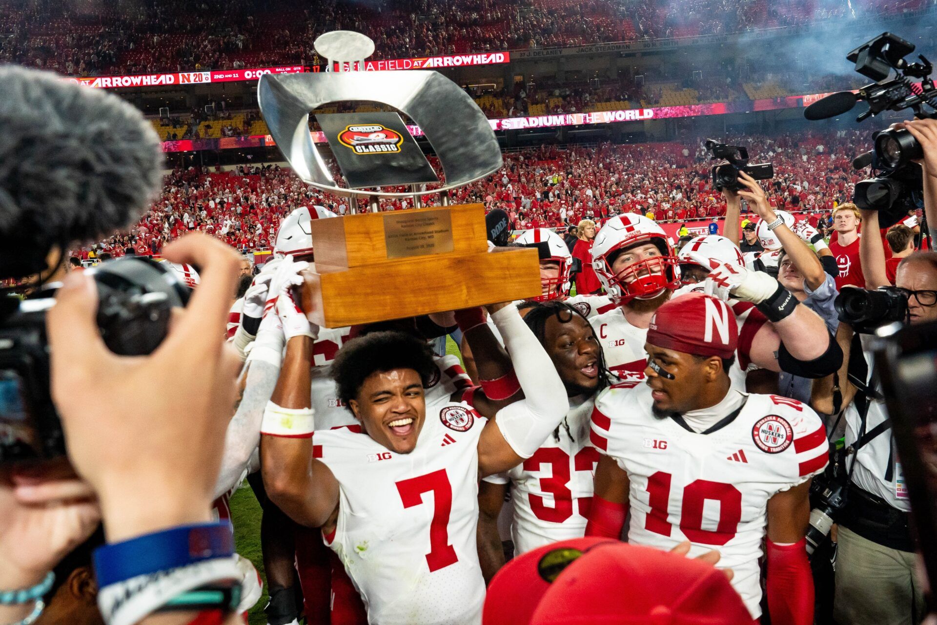 Nebraska Cornhuskers defensive back Malcolm Hartzog Jr. (7) hoists the Battle Sports Kansas City Classic trophy after defeating the Cincinnati Bearcats at GEHA Field at Arrowhead Stadium.