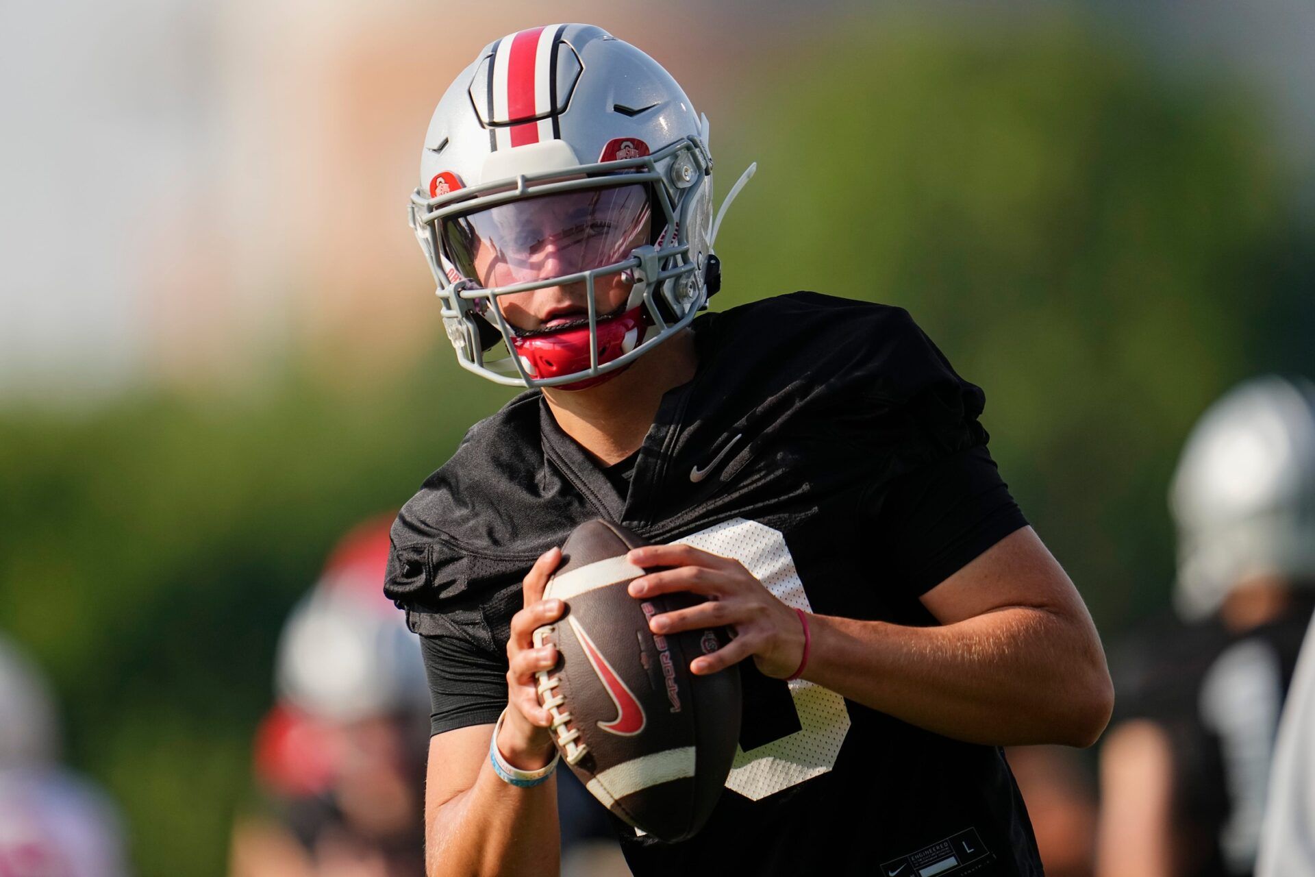 Ohio State Buckeyes quarterback Julian Sayin (10) takes a snap during football training camp at the Woody Hayes Athletic Center on Aug. 1, 2025.