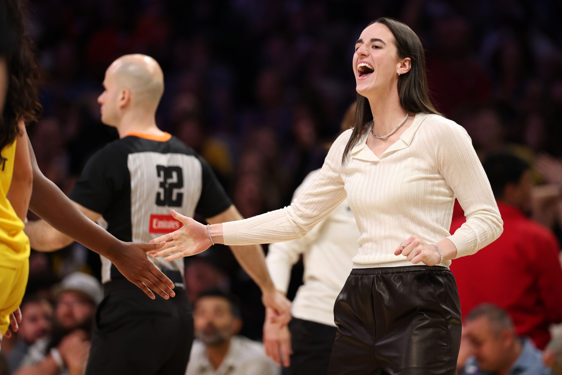 Indiana Fever guard Caitlin Clark (22) greets a teammate during the second half against the Los Angeles Sparks at Crypto.com Arena.