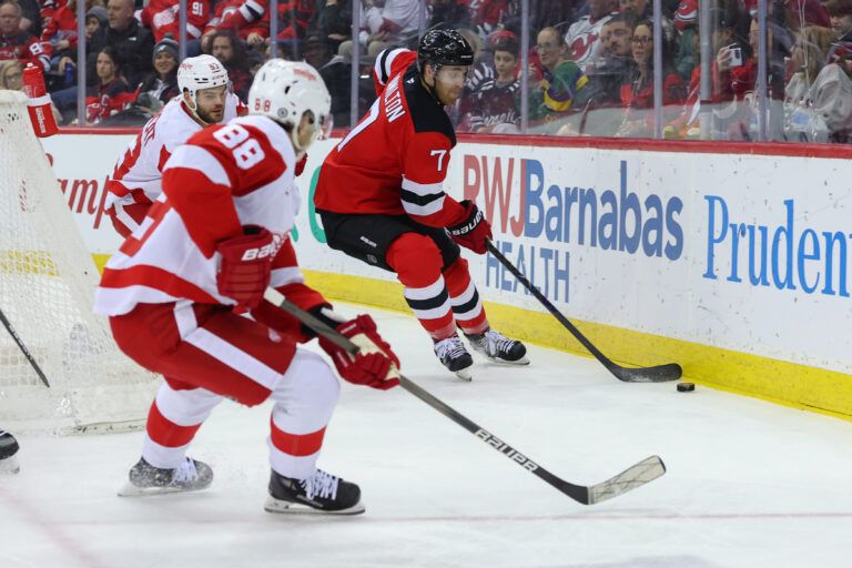 New Jersey Devils defenseman Dougie Hamilton (7) plays the puck as Detroit Red Wings right wing Patrick Kane (88) defends during the first period at Prudential Center.