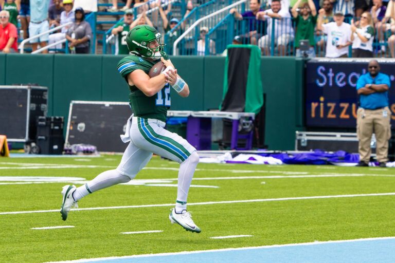 (Editors Notes:
Caption Correction) Tulane Green Wave quarterback Jake Ratzlaff (12)  rushes in for a touchdown against Northwestern Wildcats during the first half at Yulman Stadium.