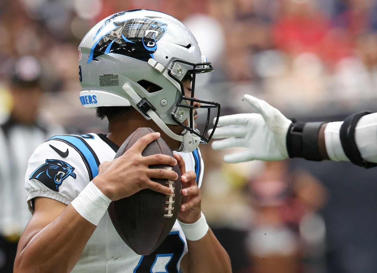 Carolina Panthers quarterback Bryce Young (9) tries to avoid the grip of Houston Texans defensive end Will Anderson Jr. (51) in the first quarter at NRG Stadium.