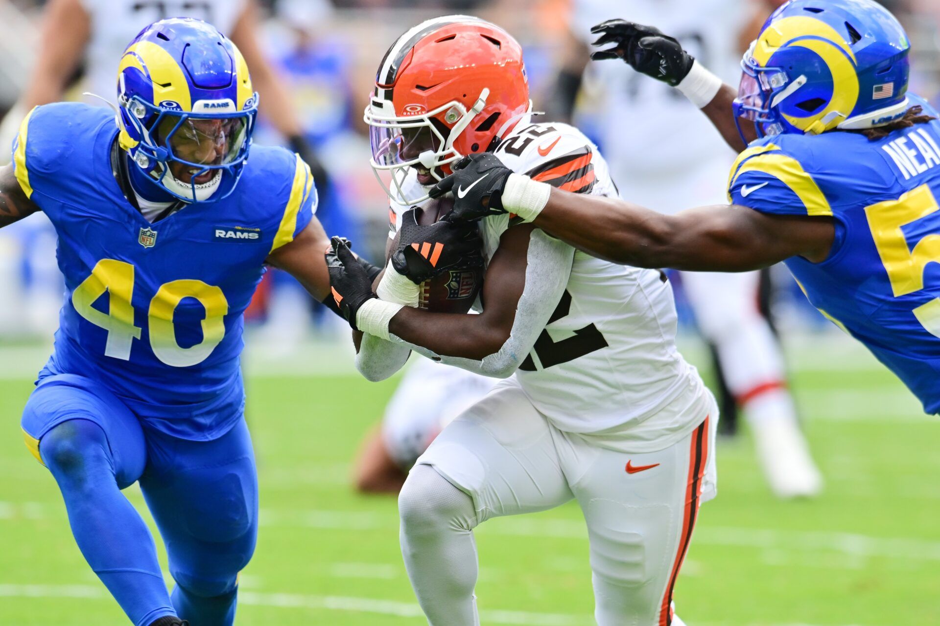 Cleveland Browns running back Dylan Sampson (22) runs with the ball against Los Angeles Rams linebacker Elias Neal (58) and linebacker Tony Fields II (40) during the first quarter at Huntington Bank Field.