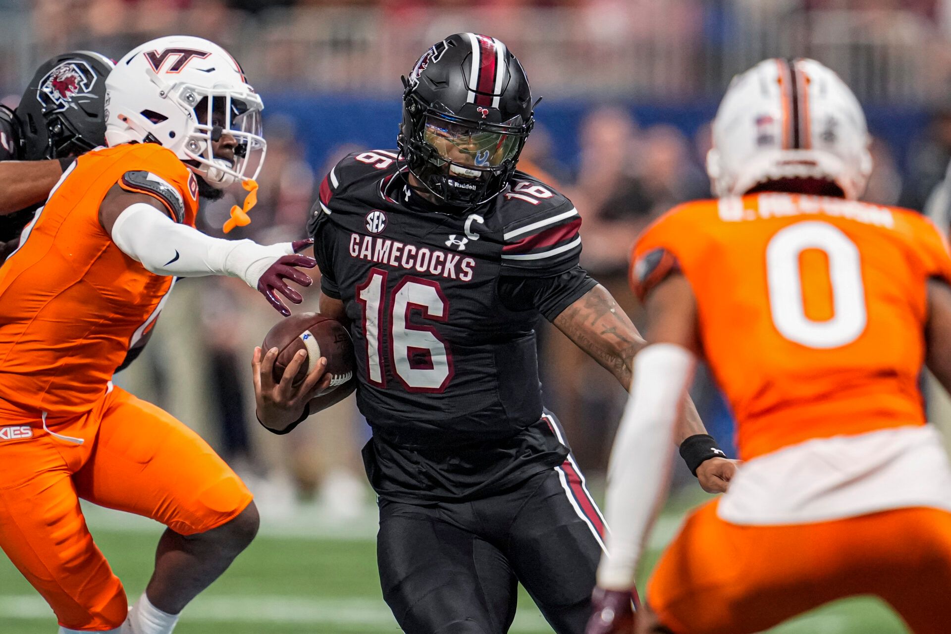 South Carolina Gamecocks quarterback LaNorris Sellers (16) runs against Virginia Tech Hokies safety Quentin Reddish (0) during the first half at Mercedes-Benz Stadium.