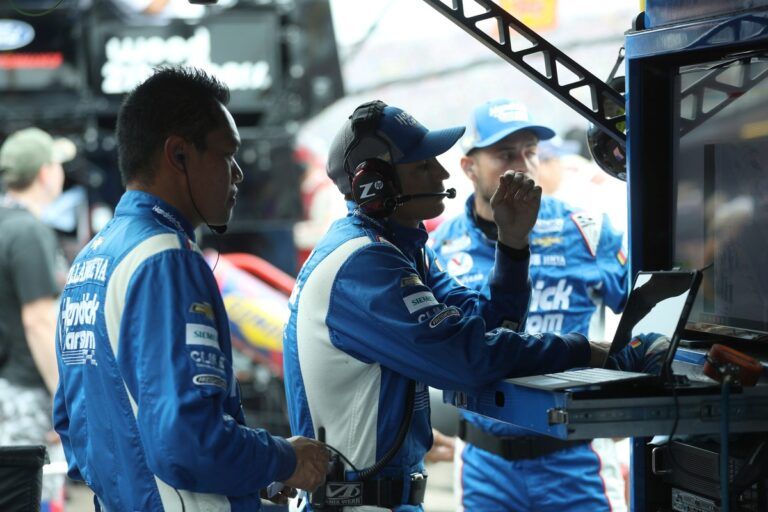 Hendrick Motorsports crew members watch the action on the track during the FireKeepers Casino 400 on Sunday, Aug. 6, 2023.