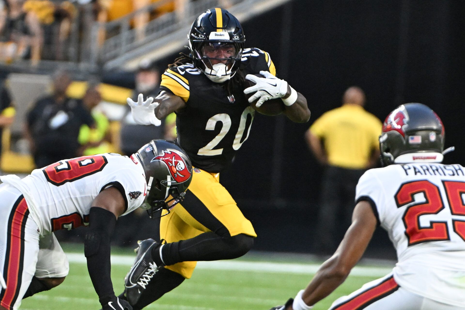 Pittsburgh Steelers running back Kaleb Johnson (20) looks to stiff arm Tampa Bay Buccaneers safety Christian Izien (29) during the second quarter at Acrisure Stadium.