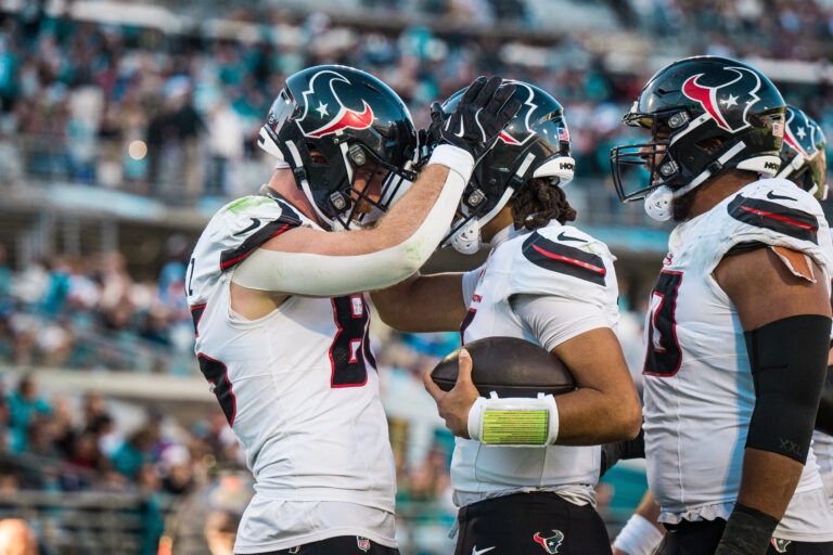 Houston Texans tight end Dalton Schultz (86) and  quarterback C.J. Stroud (7) celebrate a touchdown in the fourth quarter at EverBank Stadium.